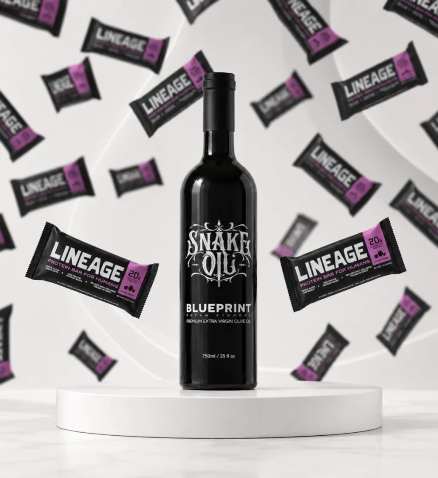 Blueprint Snake Oil extra virgin olive oil bottle on a plinth, surrounded by Lineage protein bars